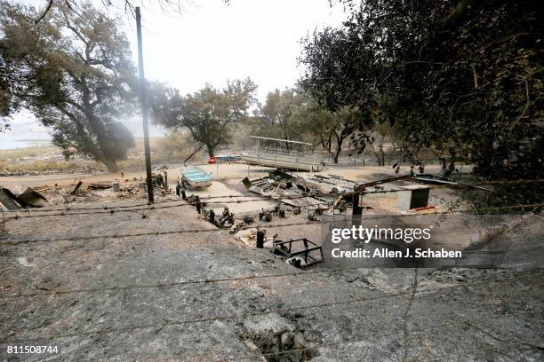 The remains of a structure and boats scorched by the Whittier Fire along SR-154 in the Los Padres National Forest near Lake Cachuma, Santa Barbara...