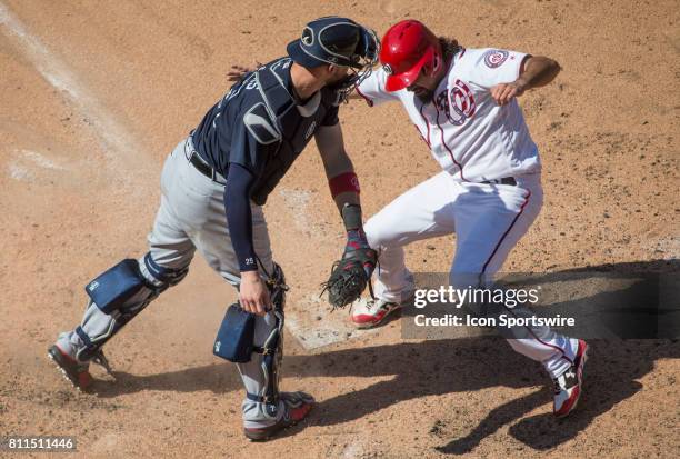 Washington Nationals third baseman Anthony Rendon slides past Atlanta Braves catcher Tyler Flowers for a home run in the eighth inning during a MLB...