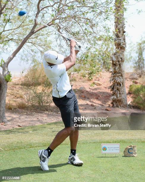 Professional basketball player Gerald Henderson Jr. Hits a tee shot during the Coach Woodson Las Vegas Invitational at Cascata Golf Club on July 9,...