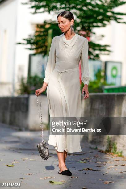 Julia Pelipas wears a white dress, outside the launch party for Chanel's new perfume 'Gabrielle', during Paris Fashion Week - Haute Couture...