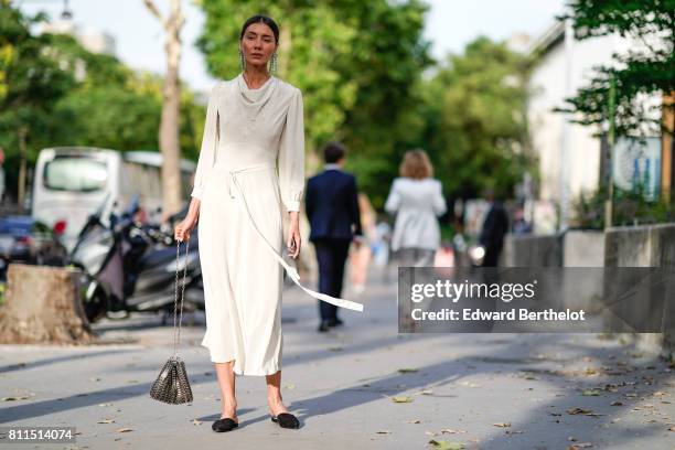 Julia Pelipas wears a white dress, outside the launch party for Chanel's new perfume 'Gabrielle', during Paris Fashion Week - Haute Couture...