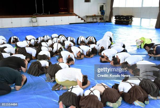 Schoolchildren take part in an evacuation drill in Saijo, Ehime Prefecture, in southwestern Japan on July 10 in the wake of North Korea's repeated...