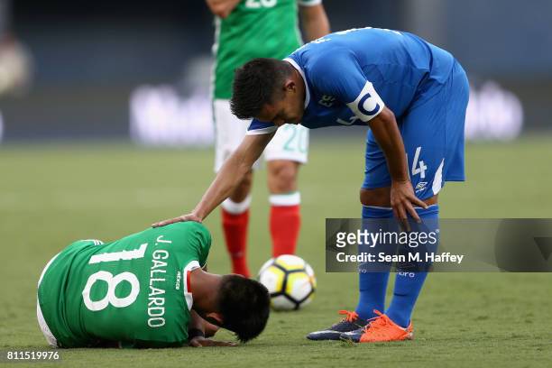 Jesus Gallardo of Mexico reacts to being tripped as Andres Flores of El Salvador touches him during the first half of a 2017 CONCACAF Gold Cup Group...