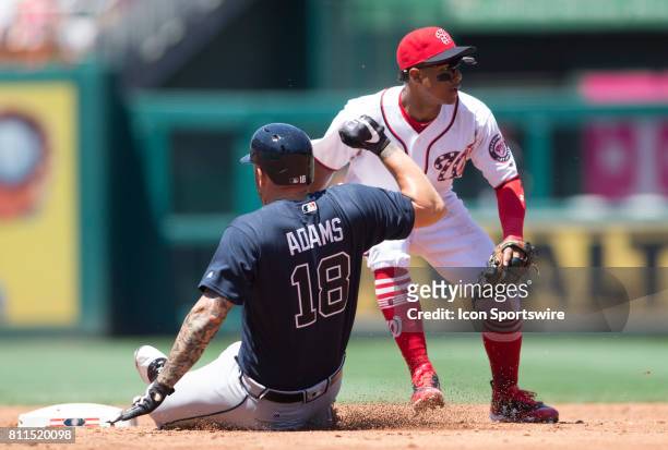 Atlanta Braves first baseman Matt Adams makes it to second base before the ball reaches Washington Nationals shortstop Wilmer Difo during a MLB game...