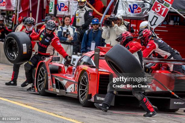 The Cadillac DPi of Dane Cameron and Eric Curran makes a pit stop during the Mobil 1 Sportscar Grand Prix IMSA WeatherTech Series race at Canadian...