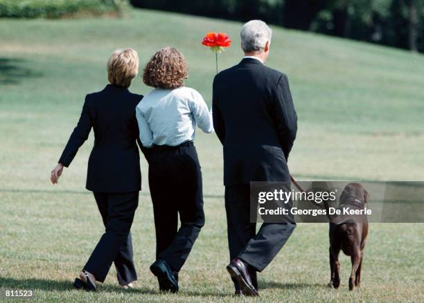 President Clinton, Hillary Rodham Clinton, daughter Chelsea, center, and dog Buddy prepare to board the Marine One helicopter on the South Lawn of...