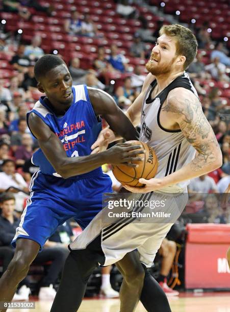 Brandon Austin of the Philadelphia 76ers fouls Shayne Whittington of the San Antonio Spurs during the 2017 Summer League at the Thomas & Mack Center...