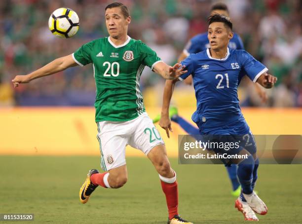 Jesus Duenas of Mexico competes for the ball with Bryan Tamacas of El Salvador during a Group C match between Mexico and El Salvador as part of Gold...