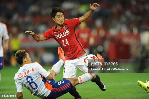 Kei Koizumi of Albirex Niigata and Takahiro Sekine of Urawa Red Diamonds compete for the ball during the J.League J1 match between Urawa Red Diamonds...