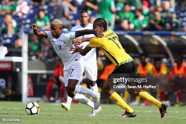 Leandro Bacuna of Curacao dribbles past Kevon Lambert of Jamaica during the second half of a 2017 CONCACAF Gold Cup Group C match at Qualcomm Stadium...