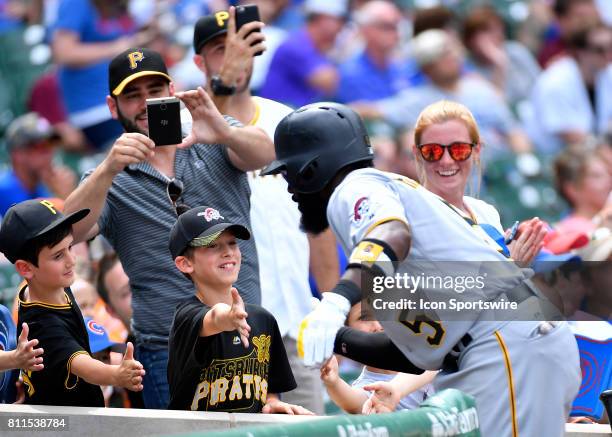 Fans celebrate with Pittsburgh Pirates left fielder Josh Harrison near the dugout after he hit a home run during the game between the Pittsburg...