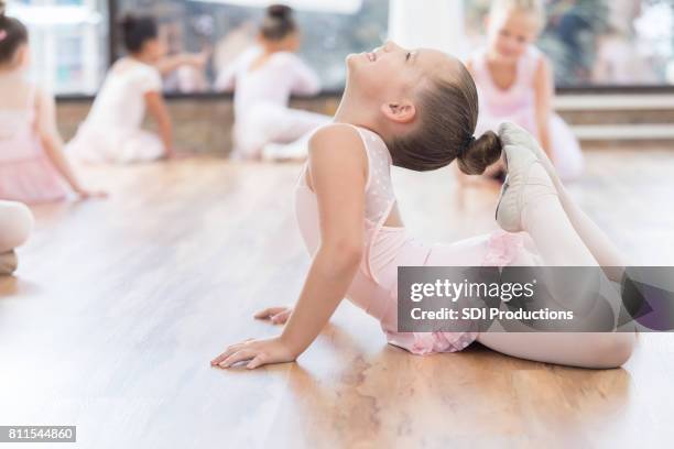 beautiful young ballet dancer warms up before class - leotard and tights stock pictures, royalty-free photos & images