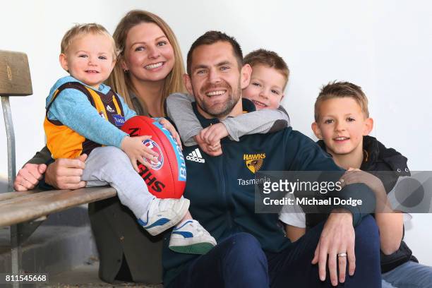 Luke Hodge poses with family after announcing his retirement on the eve of his 300th during a Hawthorn Hawks AFL press conference at Waverley Park on...