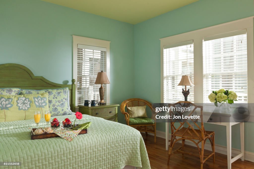 Blue-green bedroom with breakfast in bed