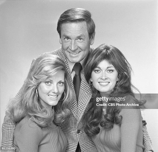 American game show host Bob Barker poses flanked by two of the so-called 'Barker's Beauties' models, Janice Pennington and Anitra Ford, for the CBS...