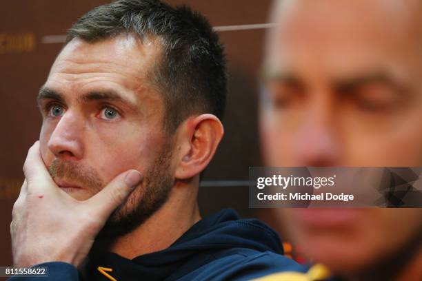 Luke Hodge reflects after announcing his retirement next to coach Alastair Clarkson on the eve of his 300th during a Hawthorn Hawks AFL press...