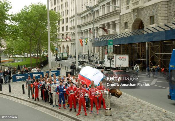 Indy 500 drivers Scott Dixon, Dan Wheldon and Ryan Briscoe pose with the rest of the field at the "Charging Bull" statue in Bowling Green Park during...
