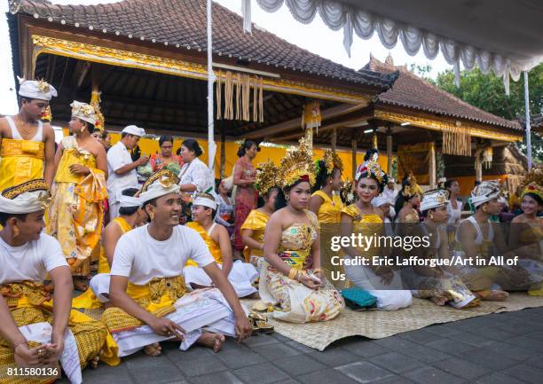 Teenagers in traditional costumes before a tooth filing ceremony taking place in a temple, Bali island, Canggu, Indonesia on July 22, 2015 in Canggu,...