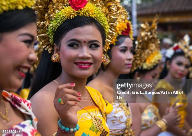 Teenagers in traditional costumes before a tooth filing ceremony taking place in a temple, Bali island, Canggu, Indonesia on July 22, 2015 in Canggu,...