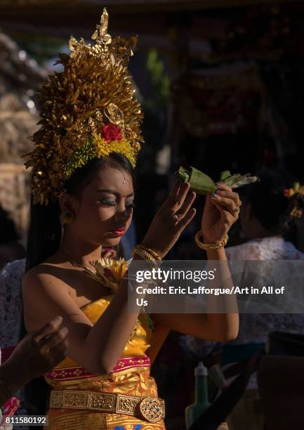 Teenage girl in traditional costume praying before a tooth filing ceremony, Bali island, Canggu, Indonesia on July 22, 2015 in Canggu, Indonesia.