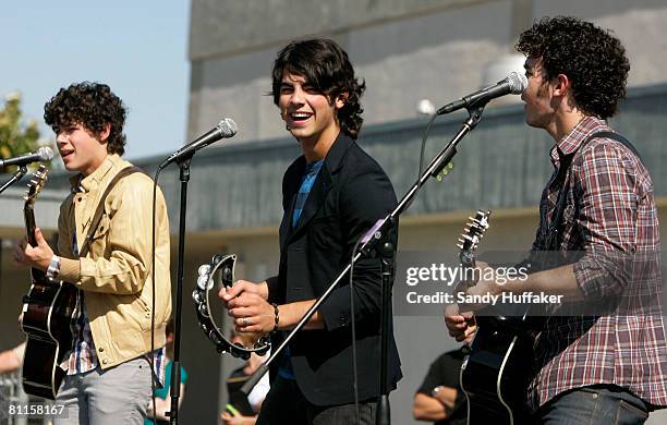 Nick Jonas, Joe Jonas and Kevin Jonas of The Jonas Brothers sing as part of the Topps Baby Bottle Pop School Concert Invasion for students at Adobe...