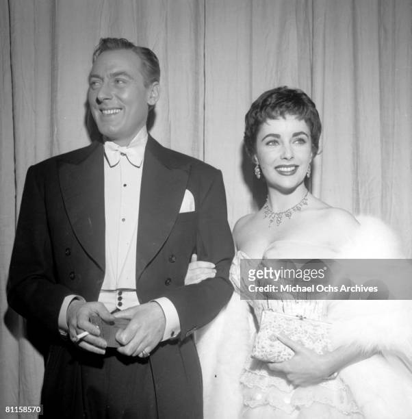 Actress Elizabeth Taylor attends an Academy Awards party at Romanoff's Restaurant with her second husband actor Michael Wilding on March 25, 1954 in...