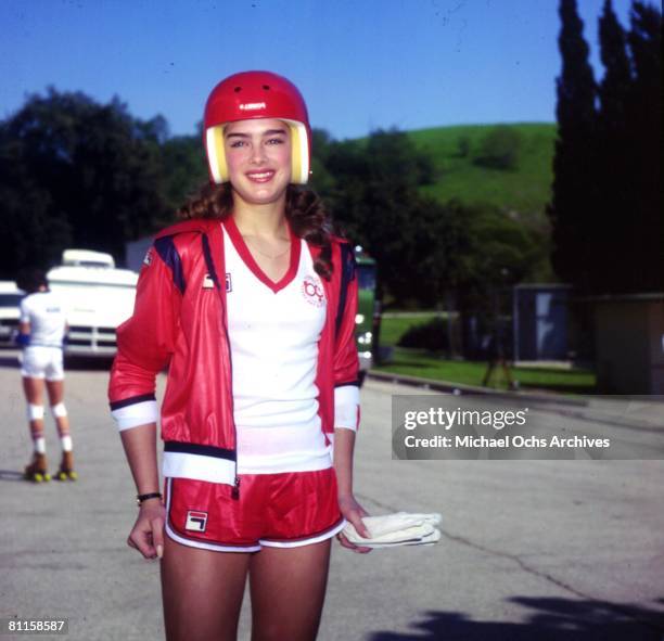 Brooke Shields wearing helmet and Fila shorts while rollerskating in 1985.