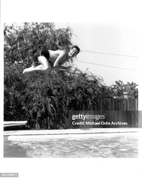 Johnny Carson host of The Johnny Carson Show on CBS, plays in his pool at home on July 5, 1956 in Los Angeles, California.