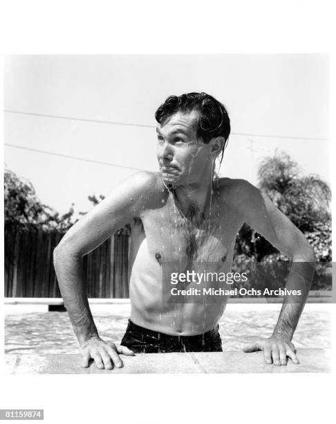 Johnny Carson host of The Johnny Carson Show on CBS, plays in his pool at home on July 5, 1956 in Los Angeles, California.