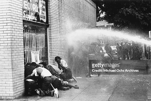 Water cannon is used on young African Americans during a protest against segregation, organized by Reverend Dr. Martin Luther King Jr. And Reverend...
