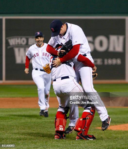 Jon Lester of the Boston Red Sox reacts with teammates Jason Varitek and Mike Lowell after throwing a no hitter against the Kansas City Royals at...