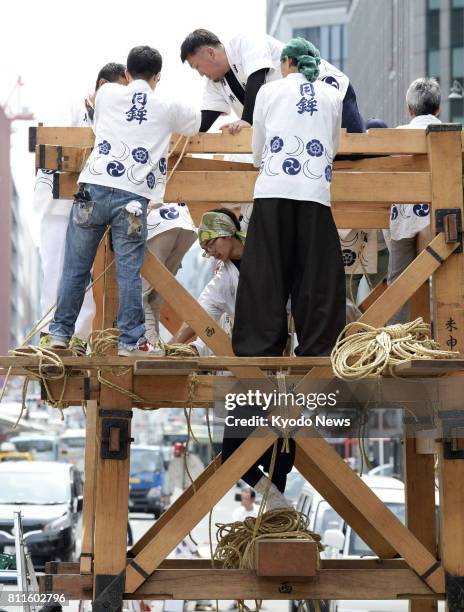 Craftworkers begin constructing Hoko floats in Kyoto on July 10 for a procession at the Gion Festival. The decorated floats, put together without...