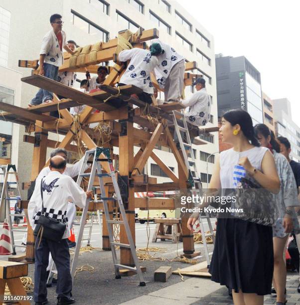 Craftworkers begin constructing Hoko floats in Kyoto on July 10 for a procession at the Gion Festival. The decorated floats, put together without...