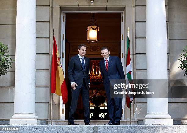 Spain's Prime Minister Jose Luis Rodriguez Zapatero stands flanked by chats with Basque premier Juan Jose Ibarretxe upon his arrival at La Moncloa...