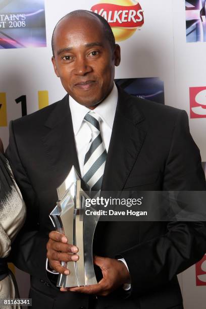 Anthony Hamilton, father of Formula One racing driver Lewis Hamiliton, poses in front of the winners' boards with his son's Britain's Best in Sport...