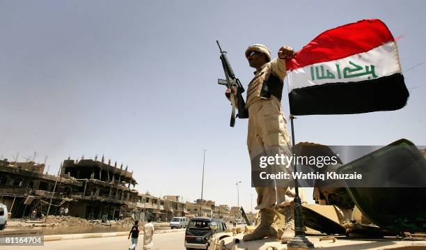 An Iraqi army soldier stands guard at a checkpoint on May 20, 2008 in the Shiite district of Sadr City in Baghdad, Iraq. Iraqi security forces have...