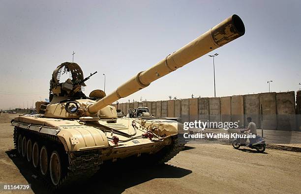 Iraqi army soldiers drive a tank down a street on May 20, 2008 in the Shiite district of Sadr City in Baghdad, Iraq. Iraqi security forces have moved...