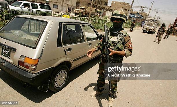 Iraqi commandos stand guard at a checkpoint on May 20, 2008 in the Shiite district of Sadr City in Baghdad, Iraq. Iraqi security forces moved into...