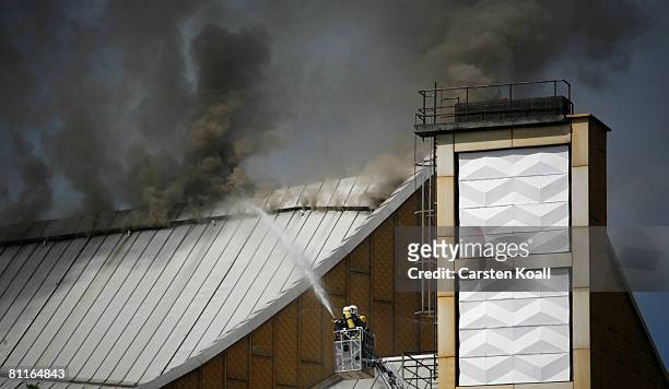 Smoke rises at the Berlin Philharmonic near Potsdamer Platz on May 20, 2008 in Berlin, Germany as fire fighters try to extinguish a fire. A fire...