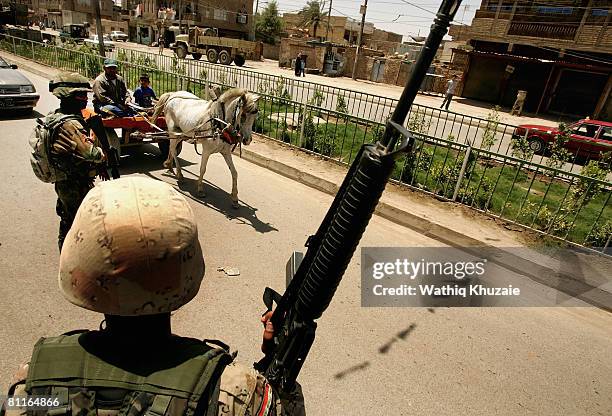 Iraqi commandos stand guard at a checkpoint on May 20, 2008 in the Shiite district of Sadr City in Baghdad, Iraq. Iraqi security forces moved into...