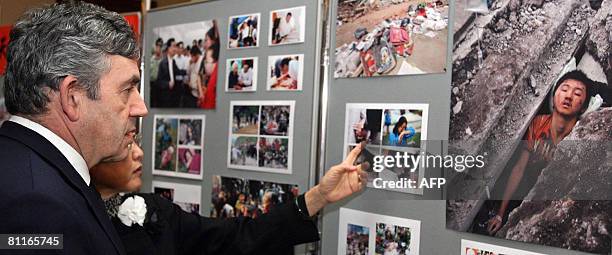 British Prime Minister Gordon Brown is pictured with Chinese ambassador Fu Ying as he looks at pictures of devastation caused by the Sichuan...