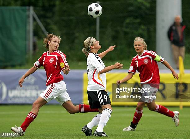 Svenja Huth of Germany heads the ball against Britta Olsen and Line Sigvardsen Jensen of Denmark during the European Women's U17 Championship match...