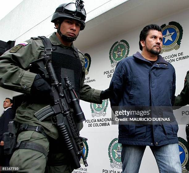 Alleged drug trafficker Gildardo Rodriguez Herrera, a.k.a "The Man of the Red Shirt", is escorted by the Colombian police to a press conference in...