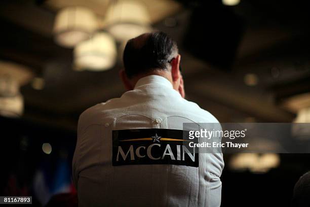 Supporter listens to Republican presidential candidate Senator John McCain speak during a town hall meeting in the Royal Poinciana Ballroom at the...