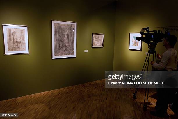 Cameraman takes a shot of a picture of a painting by Spanish painter Remedios Varo on display at the Museum of Contemporary Art in Mexico City, on 20...