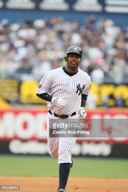 Wilson Betemit of the New York Yankees runs the bases after hitting a home run during the game against the Cleveland Indians at the Yankee Stadium in...