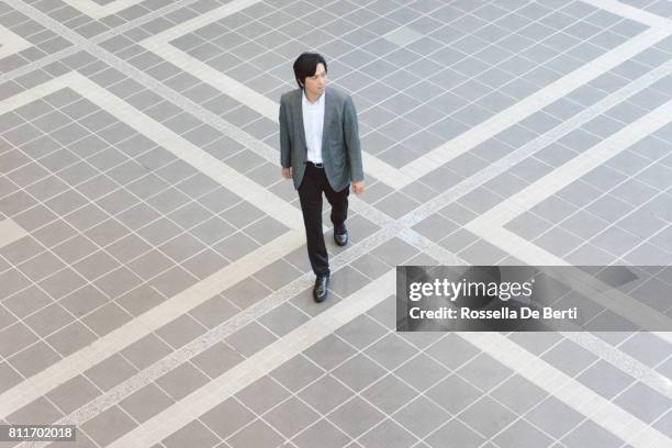 japanese businessmen walking to the office - overhead view walking stock pictures, royalty-free photos & images