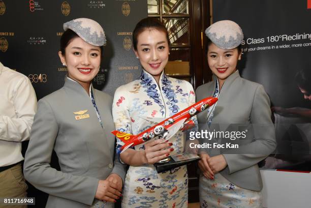 Models wearing Hainan Airlines stewardess uniforms designed by Laurence Xu pose during the Laurence Xu Haute Couture Fall/Winter 2017-2018 show as...