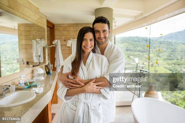 affectionate couple hugging in the bathroom - robe 2017 stock pictures, royalty-free photos & images