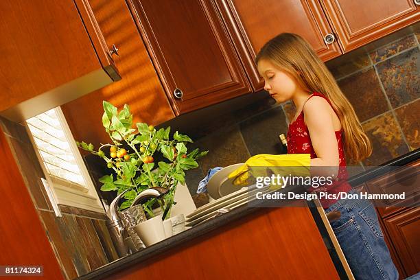 child washing dishes - design pics don hammond stock pictures, royalty-free photos & images